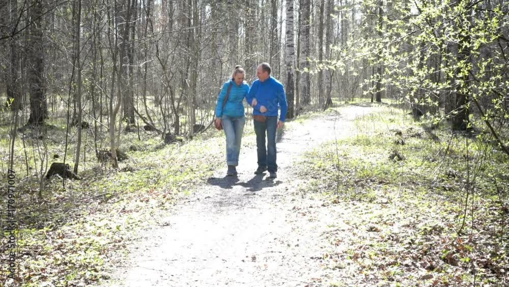 Slow motion,Happy loving couple the man and the woman walk in the spring park Slow motion,Happy loving couple the man and the woman walk in the spring park