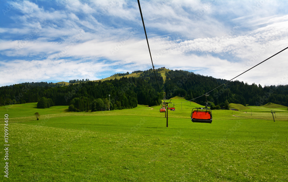 Obraz premium Chair lift transportation in Sankt Ulrich am Pillersee to Jakobskreuz Cross, Alps mountains, Austria