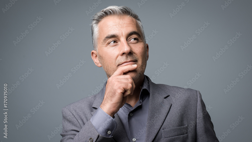 Smart businessman thinking with hand on chin Smart businessman thinking with hand on chin