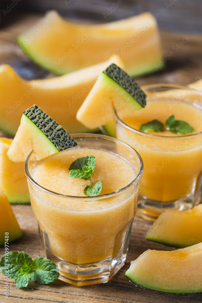 The juice of melon with mint in a glass jar on the table.Hami melon The juice of melon with mint in a glass jar on the table.Hami melon