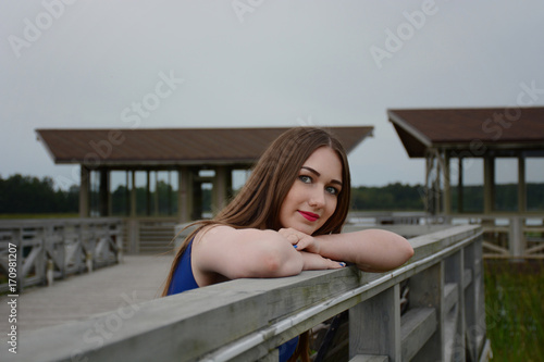 The girl with long hair on the pier