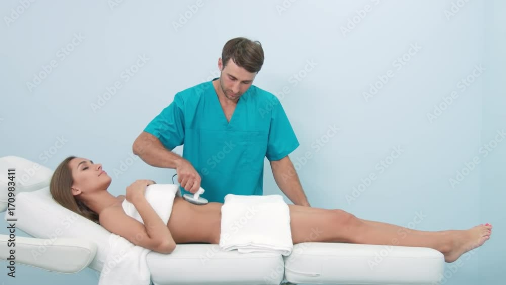 Assistant performs electrostatic belly massage Assistant performs electrostatic belly massage