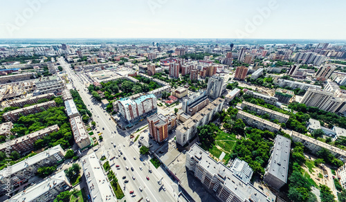 Aerial city view with crossroads and roads, houses, buildings, parks and parking lots, bridges. Helicopter drone shot. Wide Panoramic image. © mr.markin
