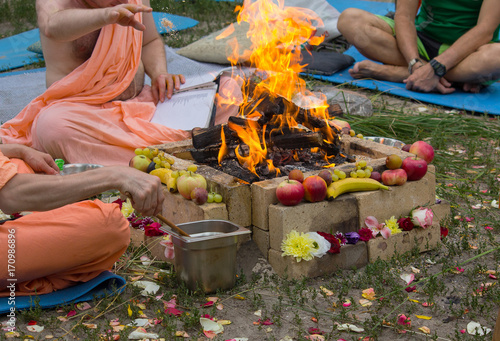 Hindu ritual with cooking and prayer reading