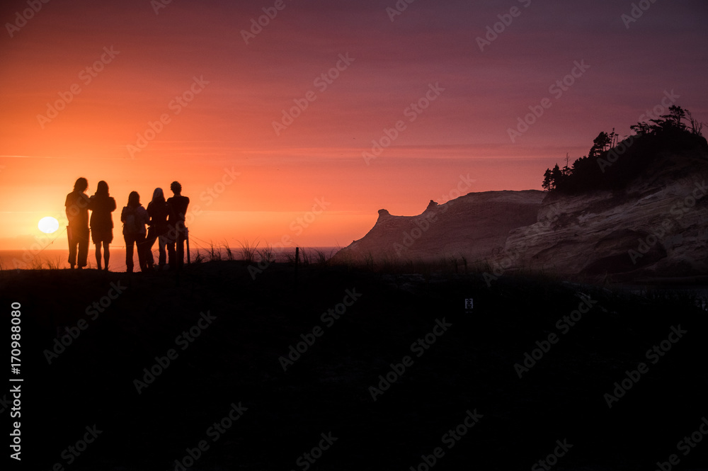 Friends at sunset on the Dune at Cape Kiwanda on the beach in Oregon