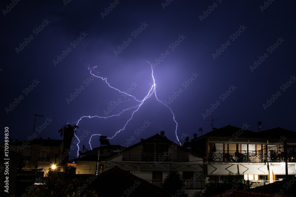 Lightning display over houses in Greece