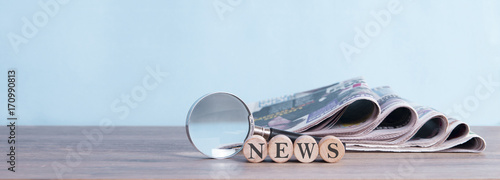 newspaper stack and magnifying glass background