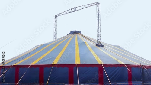 Colorful circus big top tent against a blue sky photo