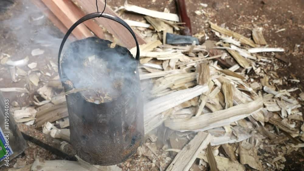 smoke from wood burning in tin can stove for keep mosquitoes and other annoying bugs away. smoke from wood burning in tin can stove for keep mosquitoes and other annoying bugs away.