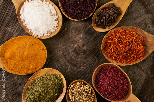Fototapeta Naklejka Na Ścianę i Meble -  Assortment of indian spices and herbs in wooden spoon
