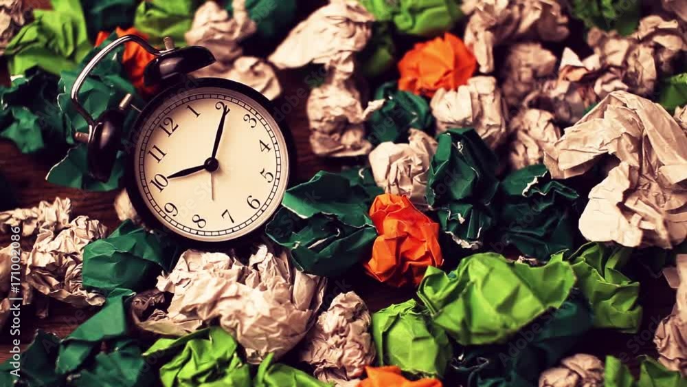 Alarm clock in a wastepaper concept for a time waste of time with cork ...