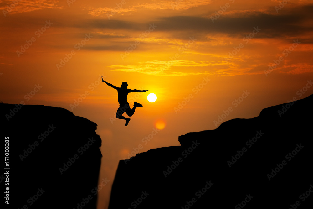 silhouette of man travel jump up for achievements successful and celebrating success with sunrise