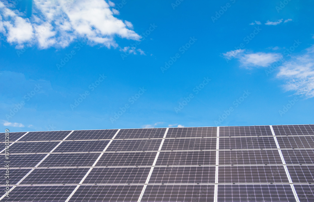 Solar power panels for innovation green energy for life with mountains and blue sky background. Solar power panels for innovation green energy for life with mountains and blue sky background.