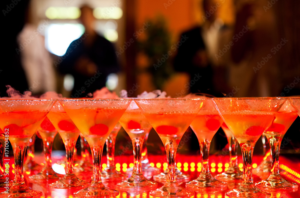 Martini glasses with dry ice highlighted in colored light