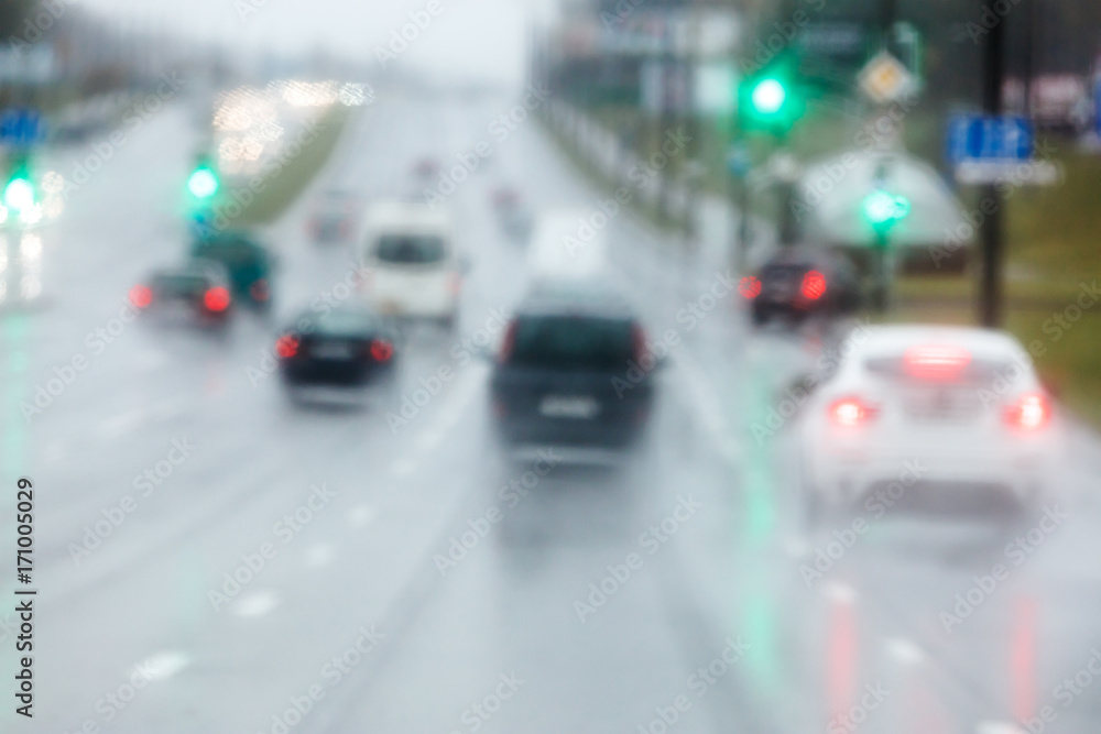 vehicles moving in the wet slippery road during the rain. looking through car windshield. 