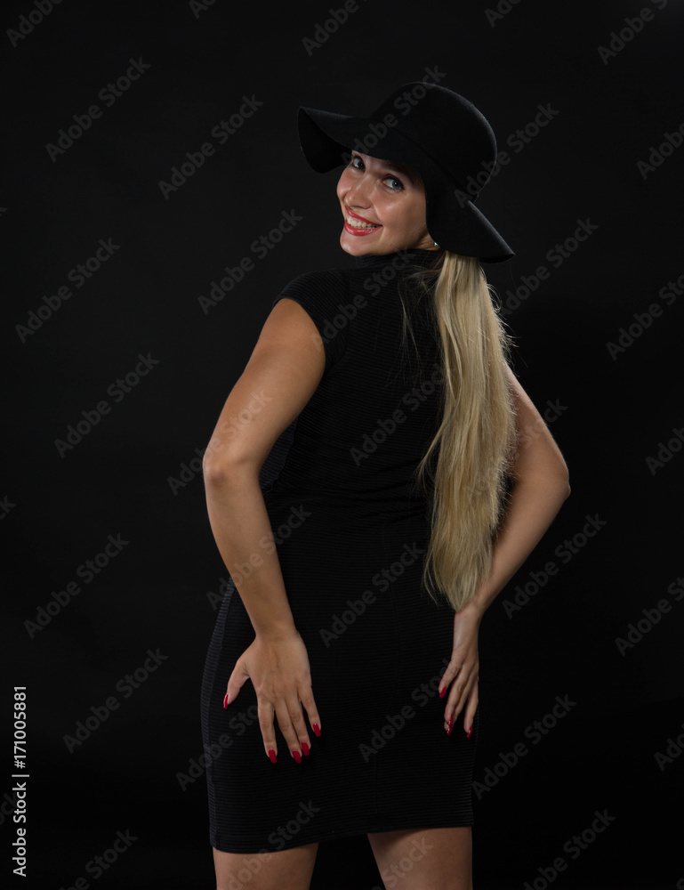 Young sexy woman portrait of a confident businesswoman showing by hands on a black background. Ideal for banners, registration forms, presentation, landings, presenting concept Young sexy woman portrait of a confident businesswoman showing by hands on a black background. Ideal for banners, registration forms, presentation, landings, presenting concept
