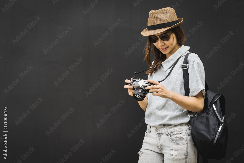 Young asian woman traveler with retro camera and backpack Young asian woman traveler with retro camera and backpack
