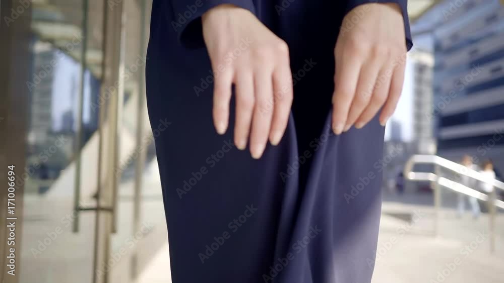 redhead model with vivid makeup is wearing in fashion dark blue chiffon dress, touching skirt redhead model with vivid makeup is wearing in fashion dark blue chiffon dress, touching skirt