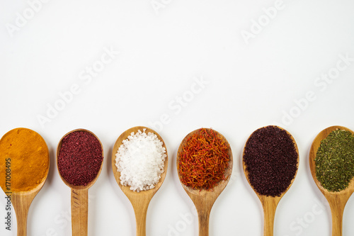 Variety of indian spices and herbs isolated on white