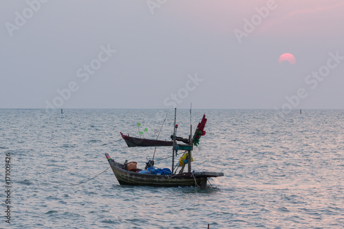small boat fishing on the ocean when sunset © bankajk