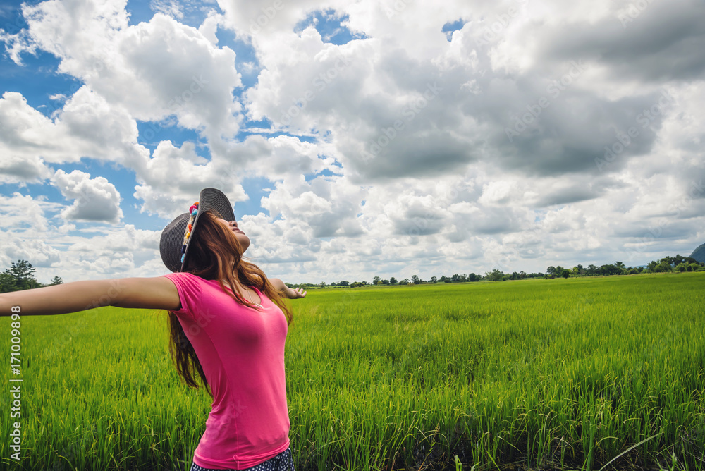 Asian women travel relax in the holiday. on a green pasture. Asian women travel relax in the holiday. on a green pasture.