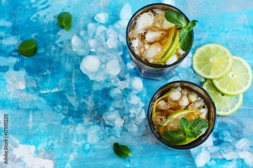 Summer cuba libre cocktail with lime and mint. Space for text