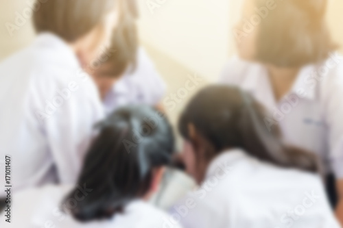 blurred of group of students in Thailand wear school uniforms sitting in line for school activities in morning, Education Concept methods contemporary educational comprises formal systems in Asia.