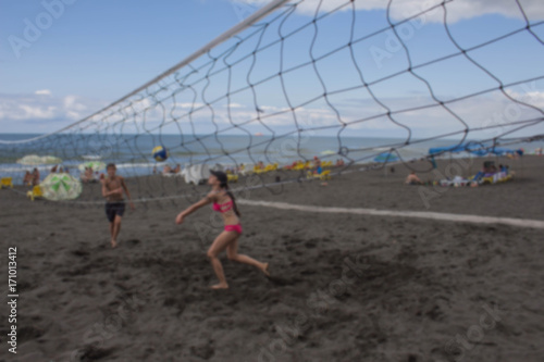 Blurred background. Teenage Friends Playing Volleyball On Beach © Khatuna