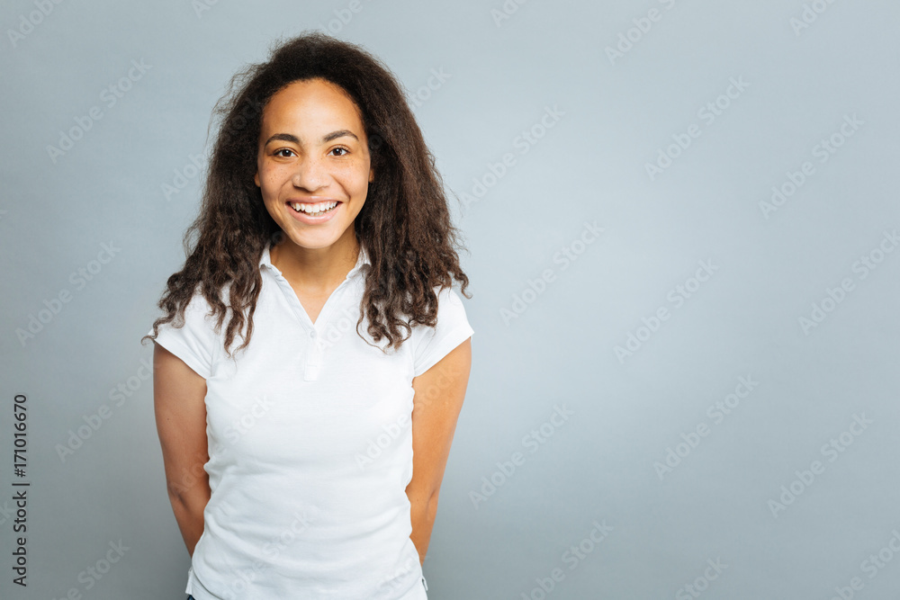Positive delighted international girl looking at camera Positive delighted international girl looking at camera