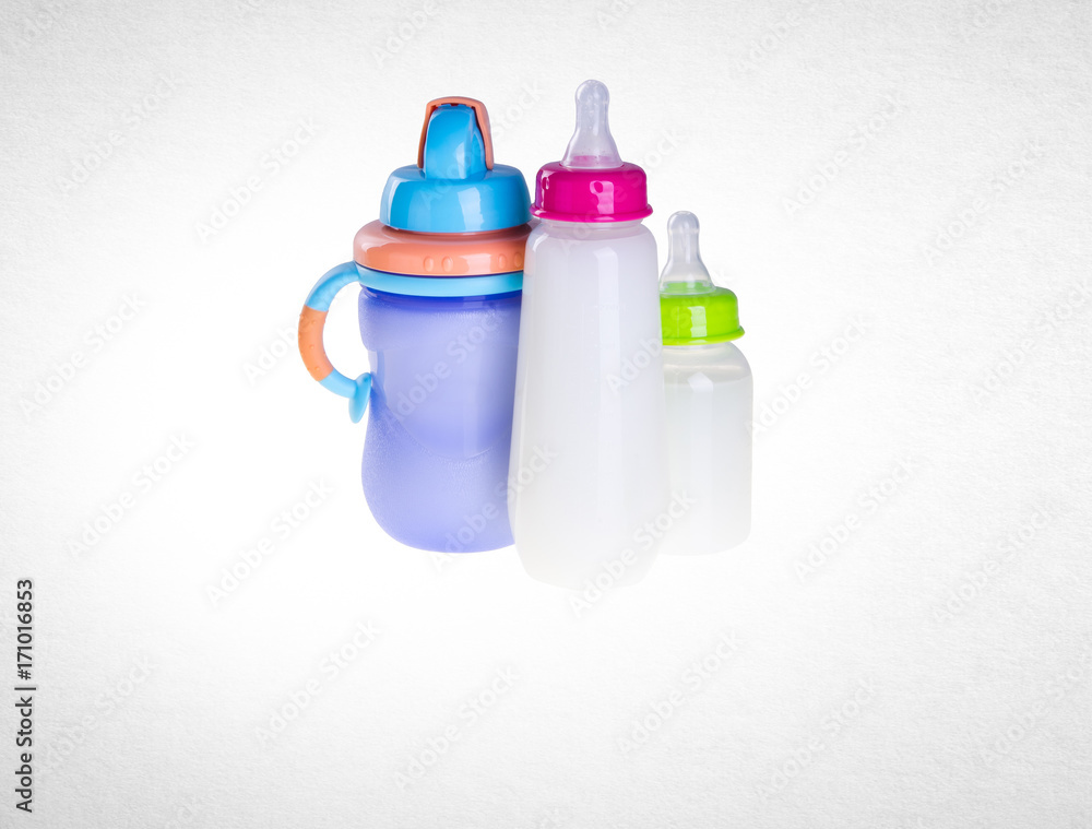 Baby bottle with milk on background Baby bottle with milk on background