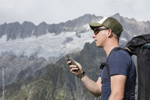 Mountaineer oriented with a GPS in the mountains