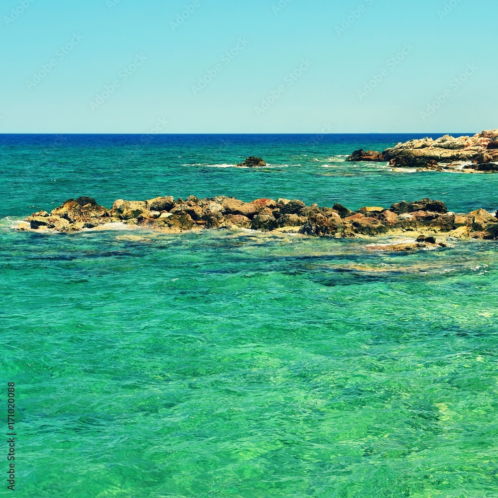 Beautiful clean sea and waves. Summer background for travel and holidays. Greece Crete.. Amazing scenery on the beach. Beautiful clean sea and waves. Summer background for travel and holidays. Greece Crete.. Amazing scenery on the beach.