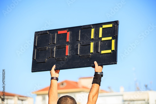 Soccer (football) referee assistant with board substitution photo