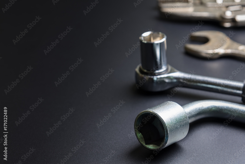 Car repair tools on the black background.selective focus. Car repair tools on the black background.selective focus.