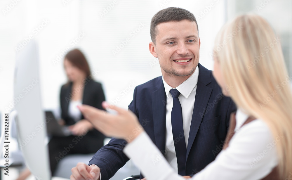 Manager talking with a colleague at the workplace Manager talking with a colleague at the workplace