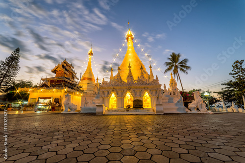 Sunset scence of White pagoda at Temple Wat Phra That Doi Kong Mu at Mae Hong Son, Thailand photo