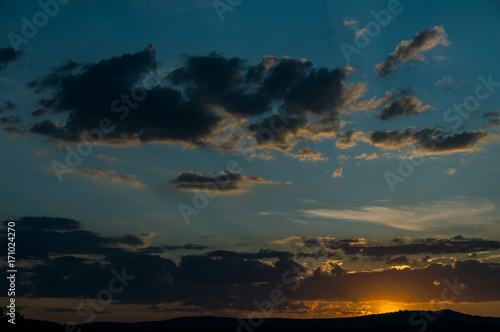 Natural Sunset Sunrise Over Field Or Meadow. Bright Dramatic Sky And Dark Ground.