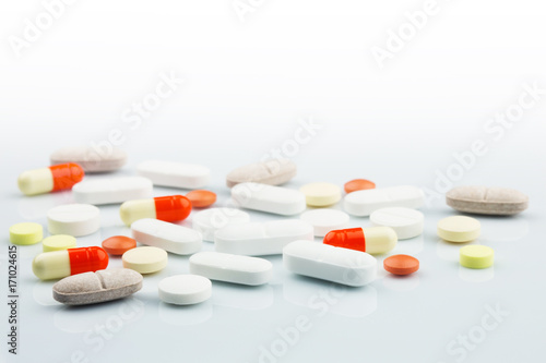 Pharmacy theme. Isolated Pills and Capsules on the White Surface. Closeup.