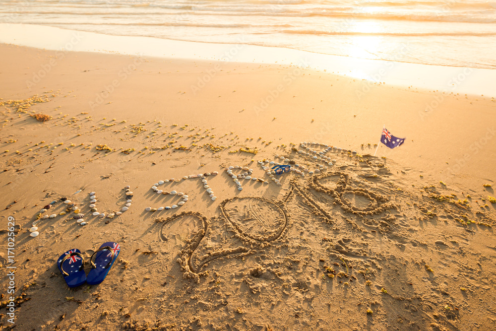 Obraz premium Australia text with thongs and sunglasses on beach