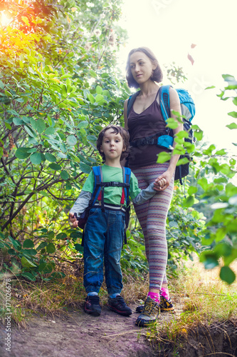 Boy and mom in the forest.