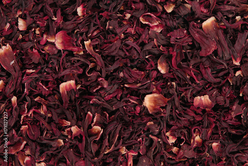 dry carcade  tea, creative texture background, red flowers of hibiscus