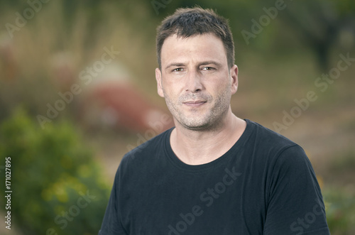 Portrait of young handsome man outdoor in summer