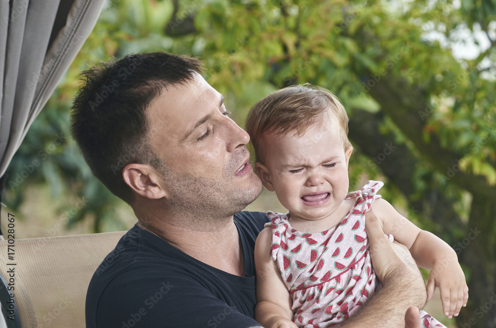 Fototapeta premium Father overwhelmed because his baby is crying