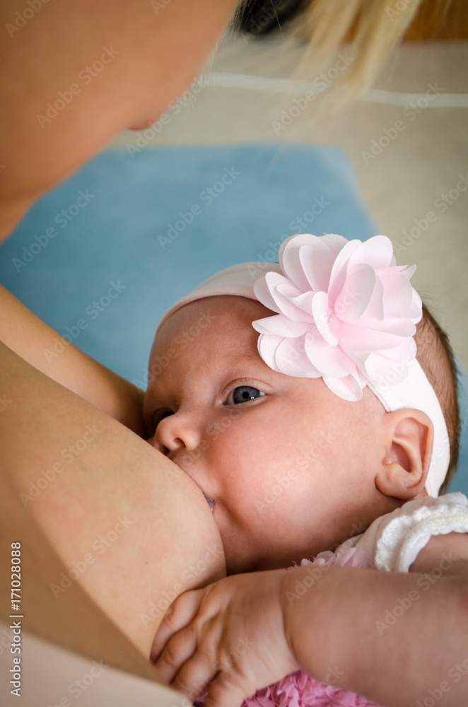 Breastfeeding baby. Mother nursing her child. Newborn eat breast milk.