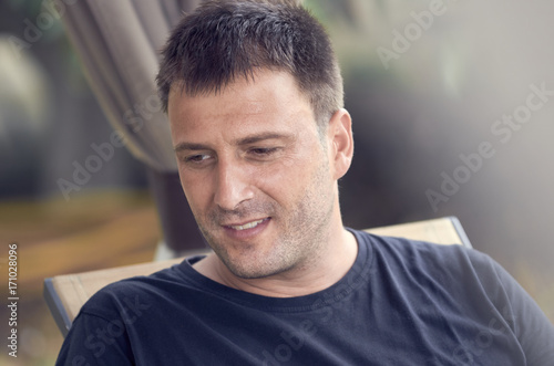 Portrait of young handsome man outdoor in summer