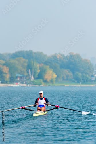 Male athlete rowing single scull