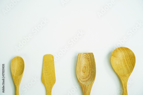 wooden spoons on white background, top view with copy space
