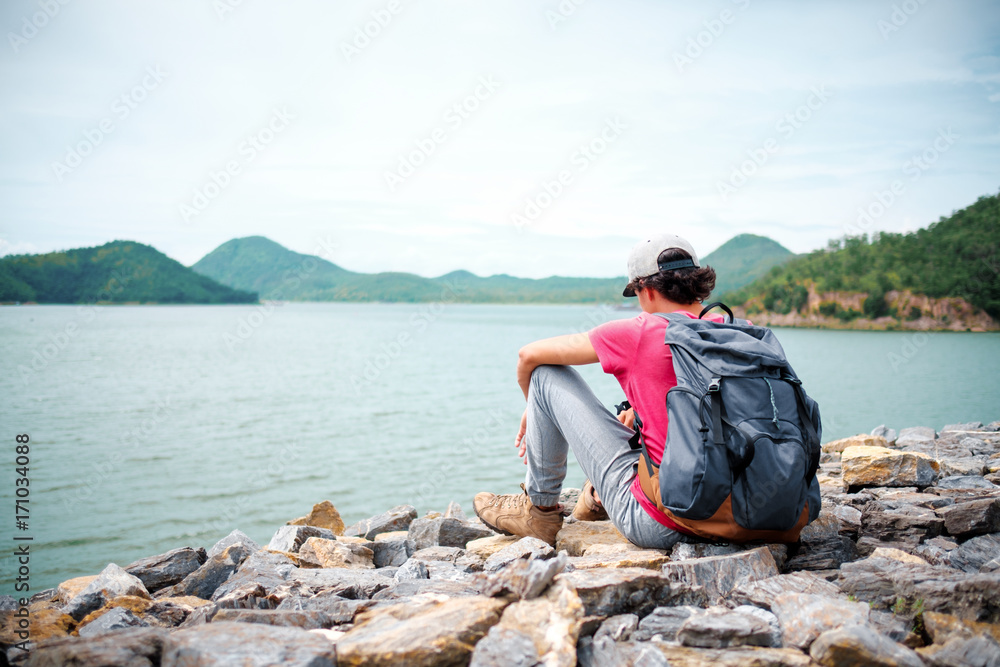 man traveling walking with backpack at national park in the jungle day time sun shine on holiday at weekend relax fresh on background nature view man traveling walking with backpack at national park in the jungle day time sun shine on holiday at weekend relax fresh on background nature view