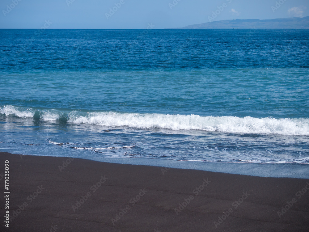 Black volcanic beach in eastern Bali Indonesia Black volcanic beach in eastern Bali Indonesia