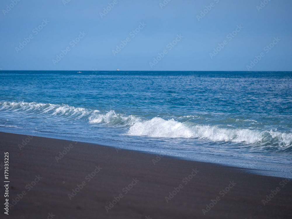 Black volcanic beach in eastern Bali Indonesia Black volcanic beach in eastern Bali Indonesia